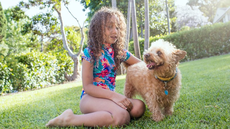 child with dog in australian backyard