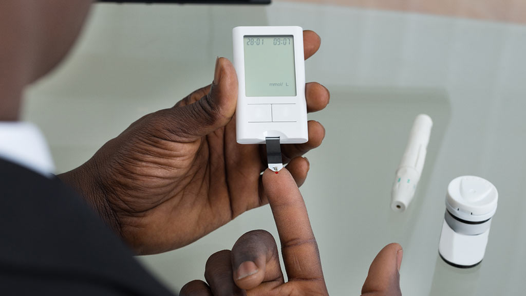 man using blood glucose meter