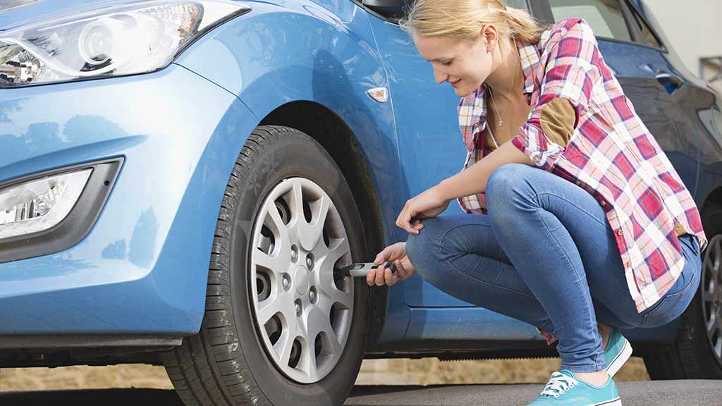woman testing her tyre pressure