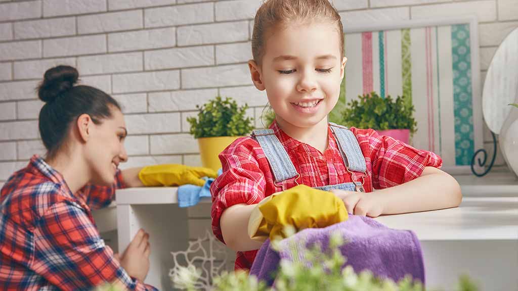 mother and daughter cleaning home