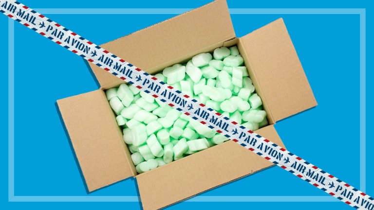 open carton full of styrofoam packing and air mail tape