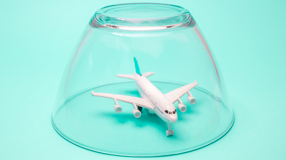 lead_plane_under_glass_cover_travel_canmcellations