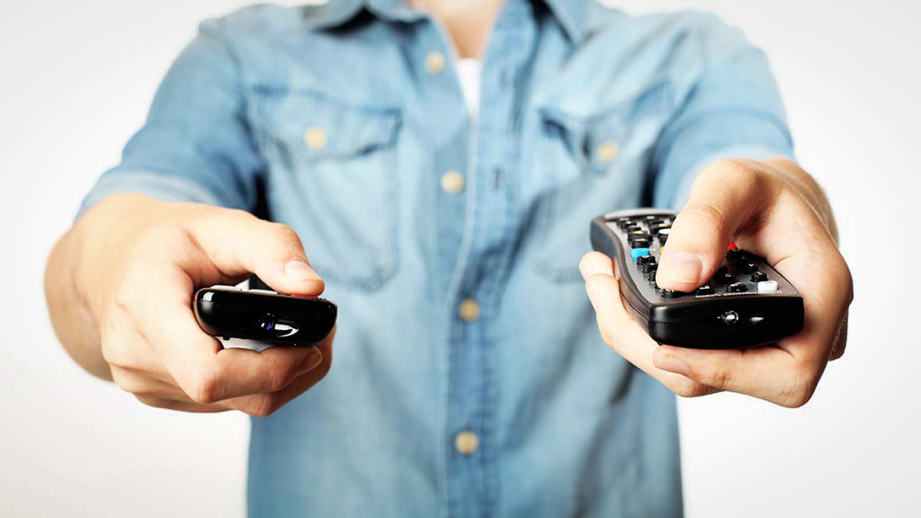 man pointing remotes at screen tv reliability