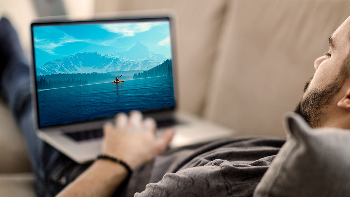man watching TV on laptop