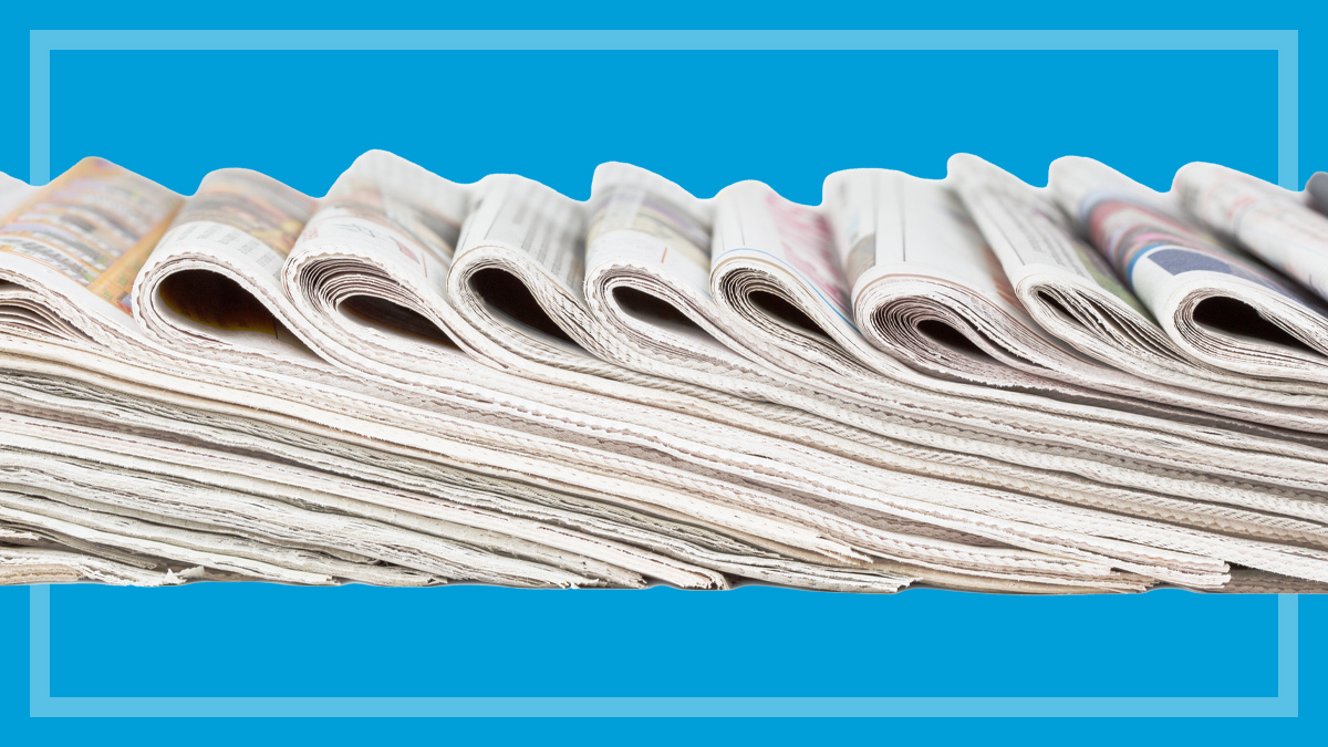 newspaper_stack_on_blue_background