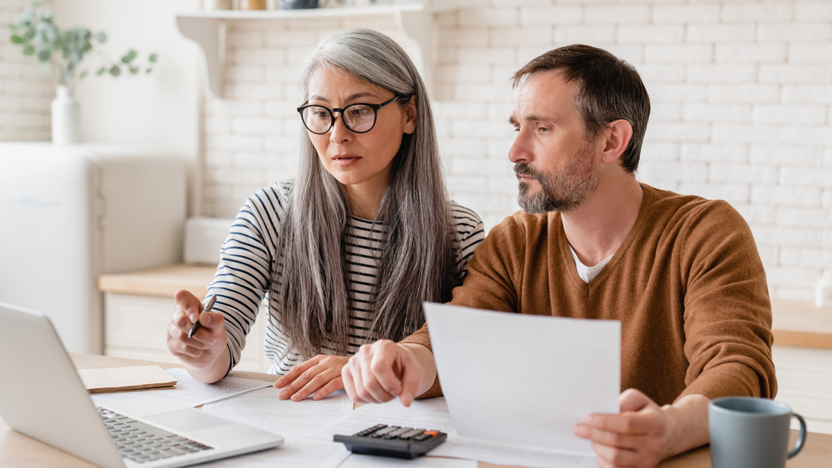 man_and_woman_looking_at_paperwork_death_nomination