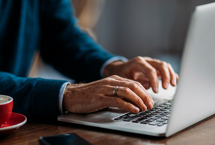 person_filling_out_survey_on_laptop