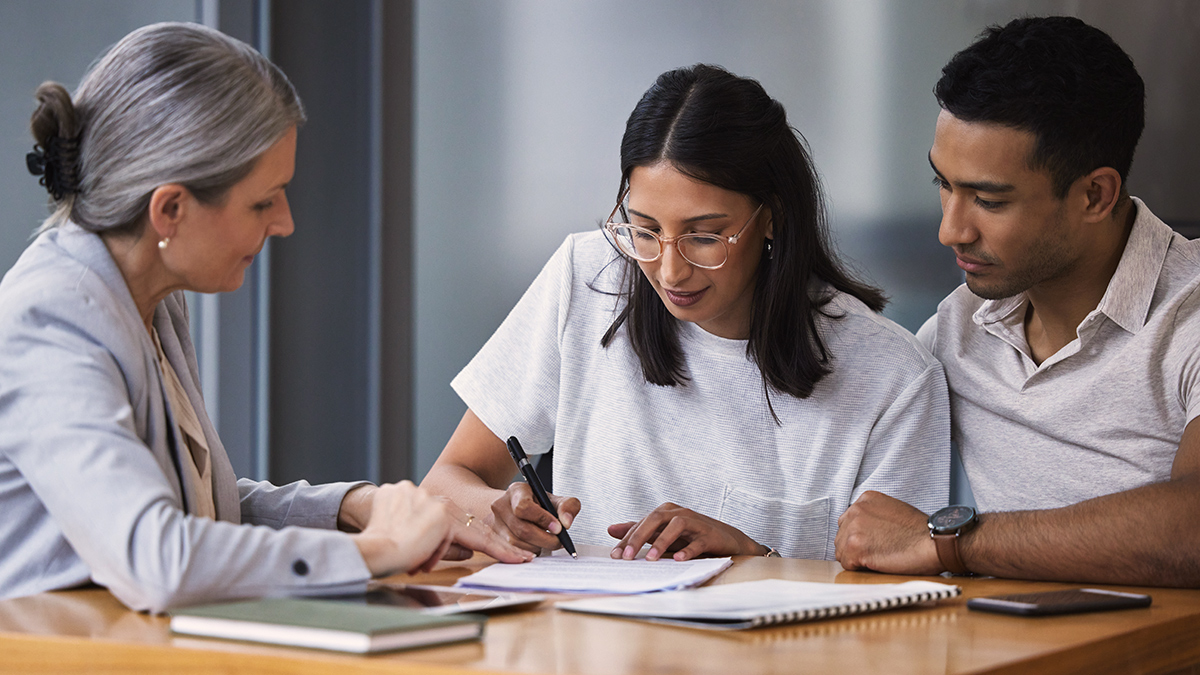 young_couple_signing_financial_document