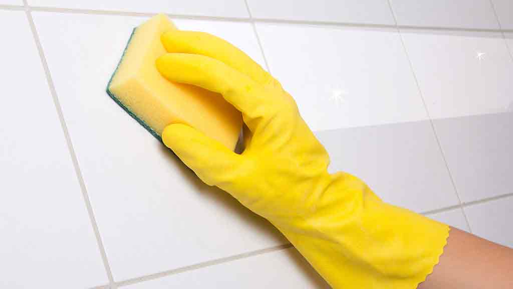 sponge cleaning bathroom tiles