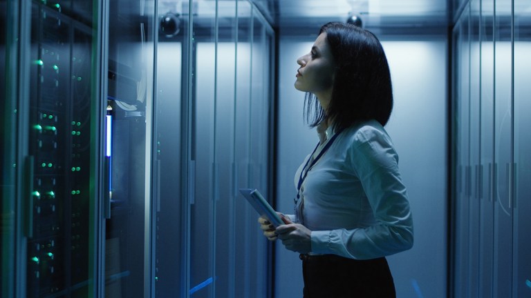 person_checking_mainframe_computer