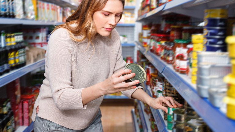 checking labels on tinned seafood