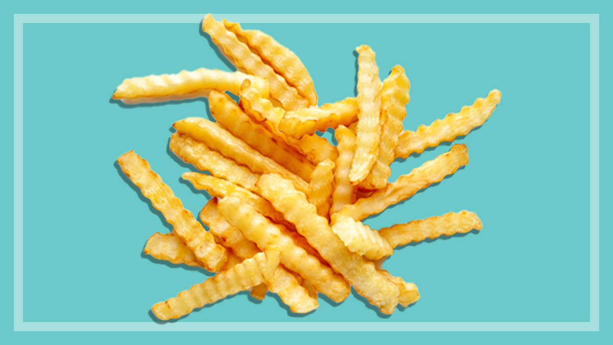 cooked frozen crinkle cut chips on a teal background