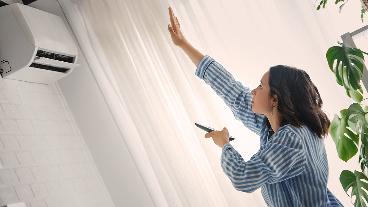 person checking the air conditioner is on