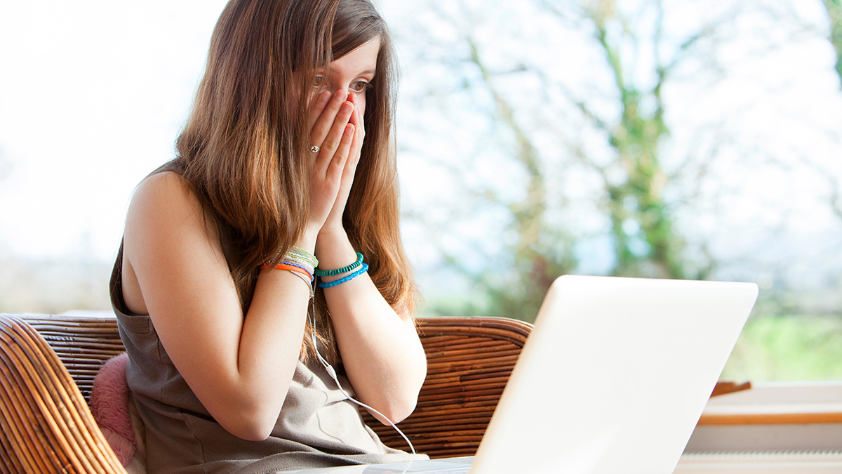 teenager_shocked_at_what_they_see_on_their_laptop_screen