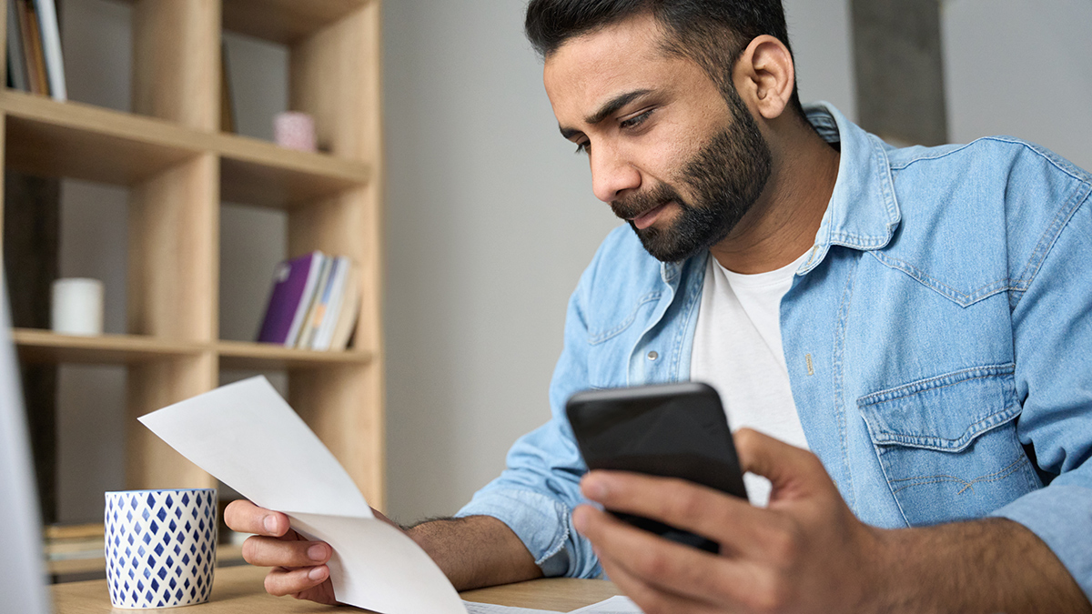 person looking at their superannuation account statement and about to call their super fund