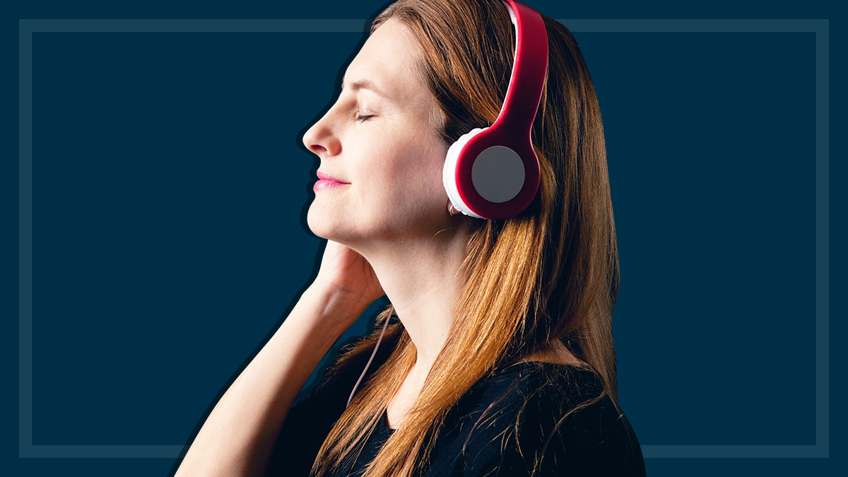 woman listens to headphones with eyes closed
