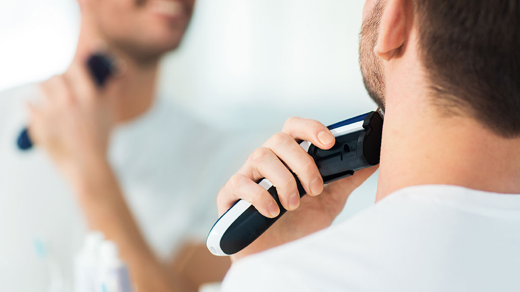 man using electric shaver HWT