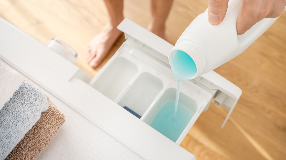 pouring_fabric_softener_into_washing_machine