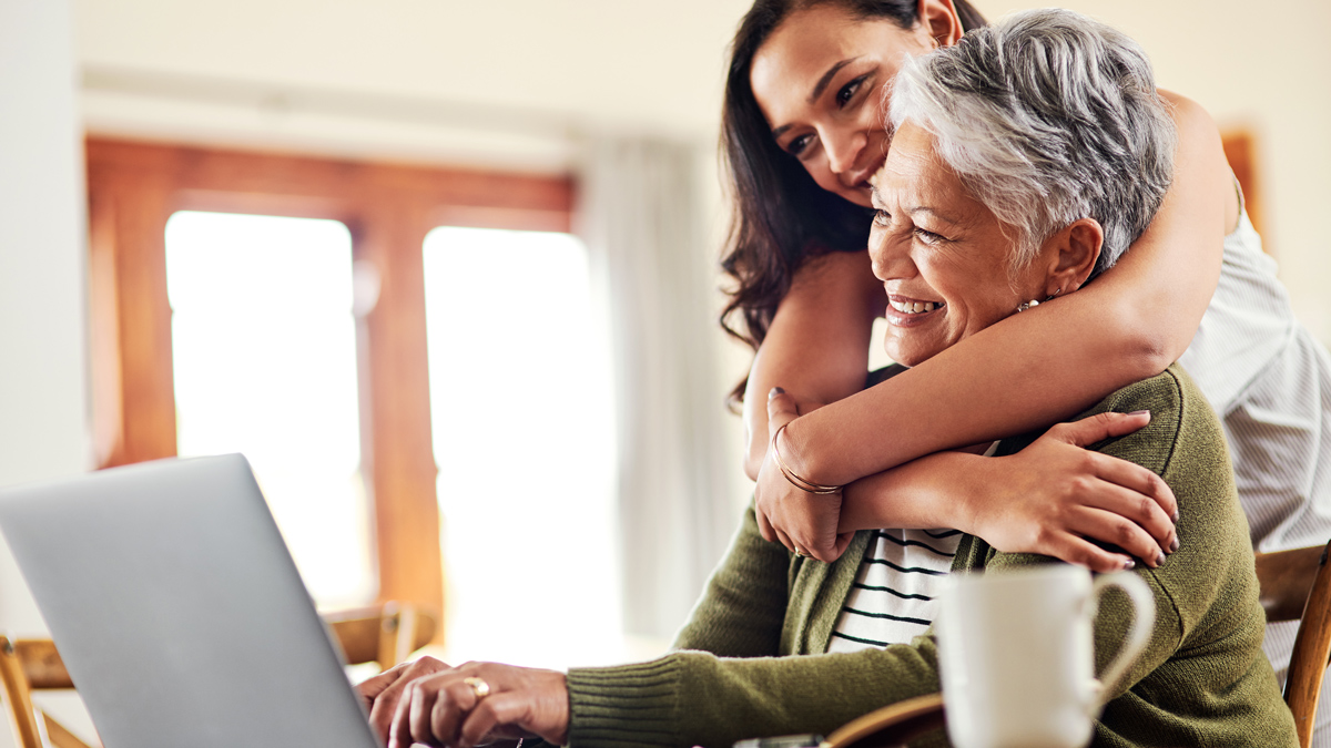 young adult with parent looking at a computer