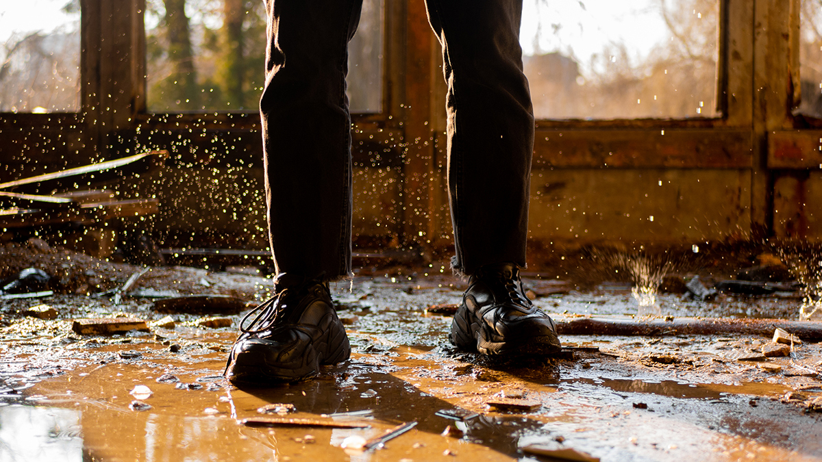 person standing in flooded house