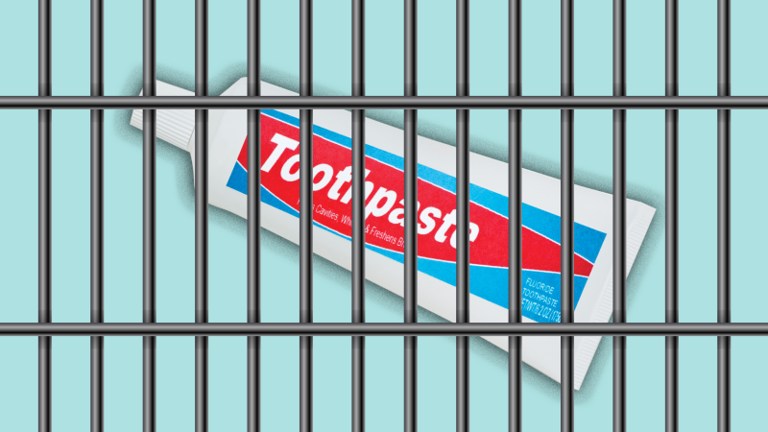 a tube of toothpaste behind metal bars