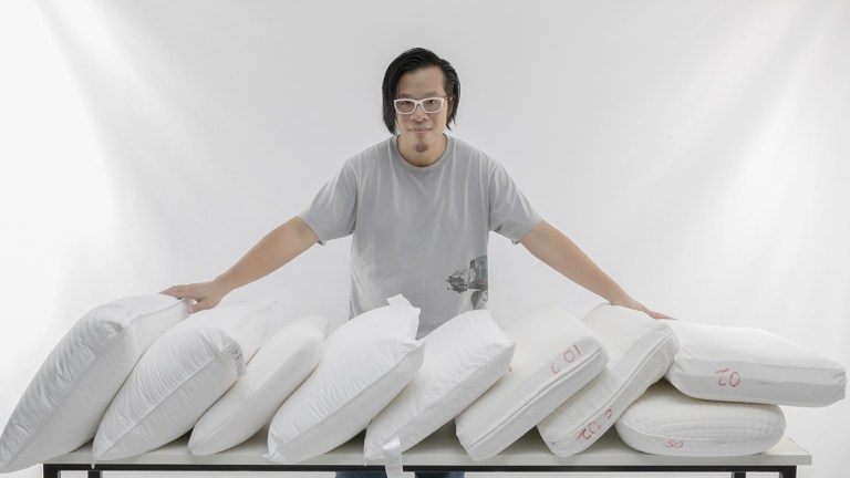 choice tester matthew tung standing behind a row of pillows