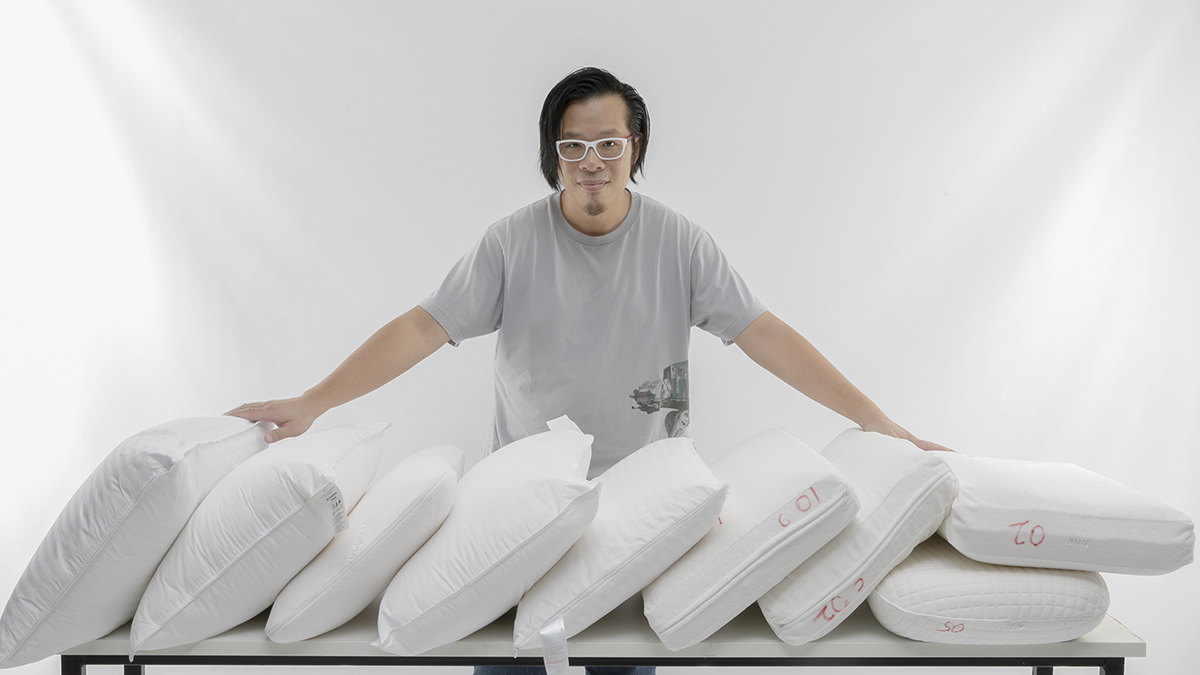 choice tester matthew tung standing behind a row of pillows