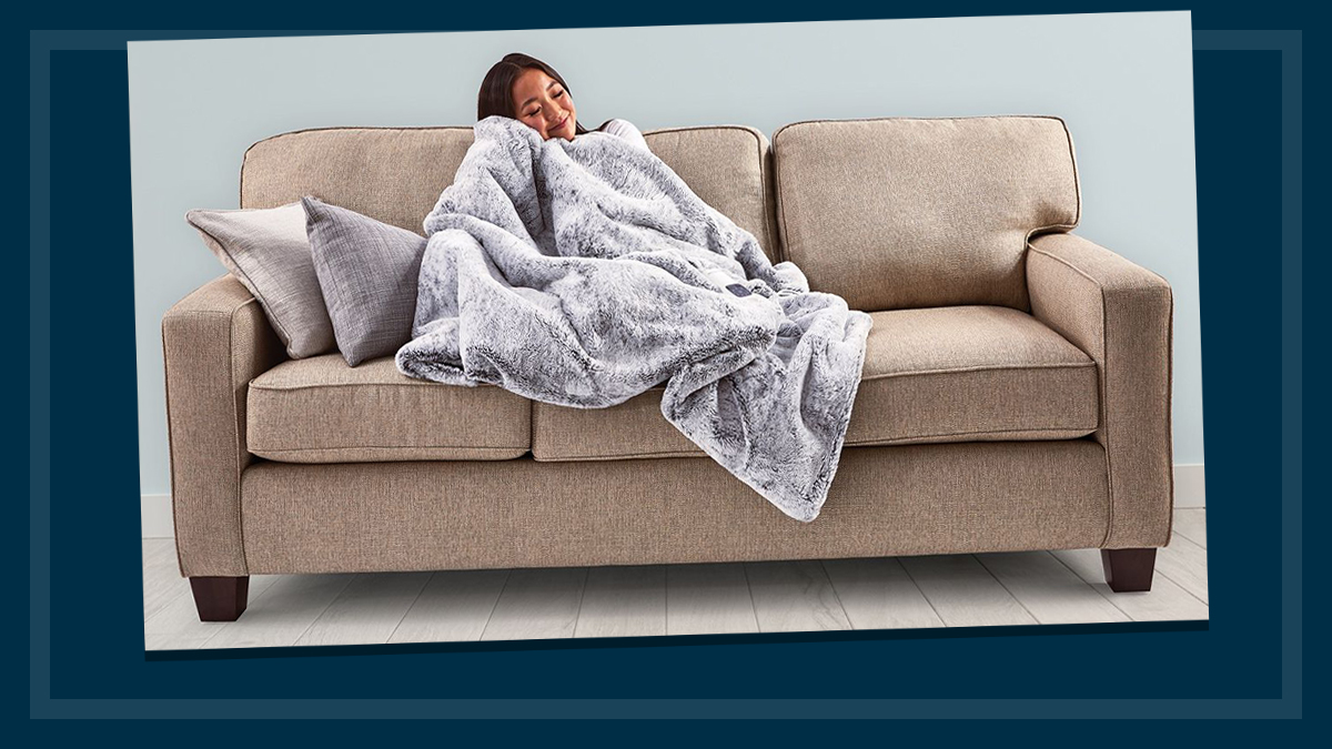 woman on sofa with heated throw