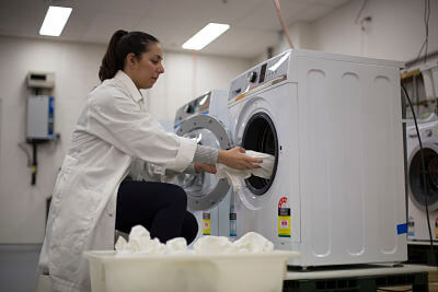 Loading washing machines for a test in the CHOICE Laundry Lab