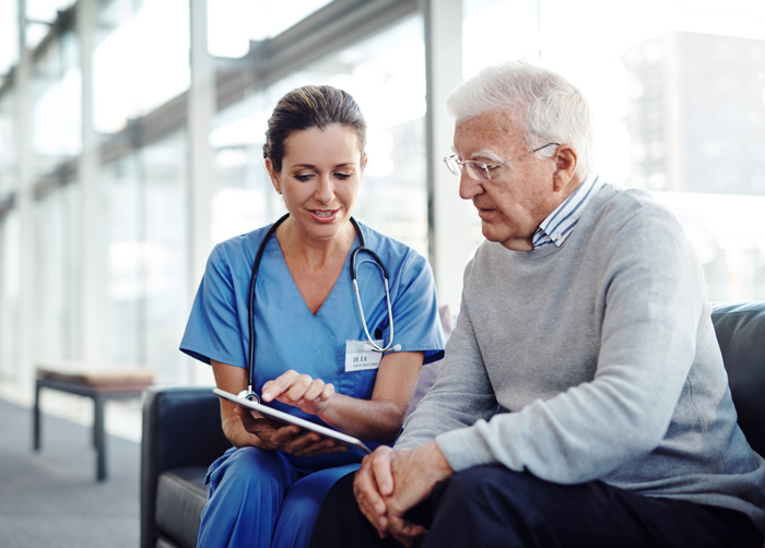 man at hospital going over documents with a doctor