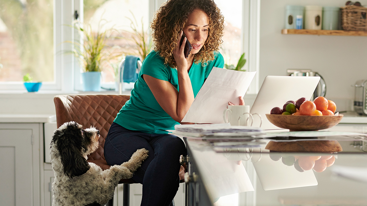 person with dog on phone discussing pet insurance